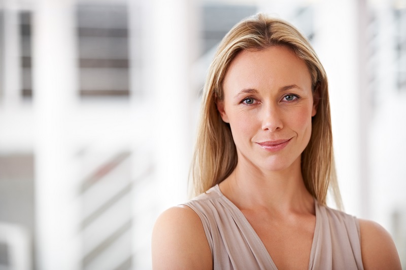 Happy woman who just had a mini facelift. Dr. Quita Lopez.